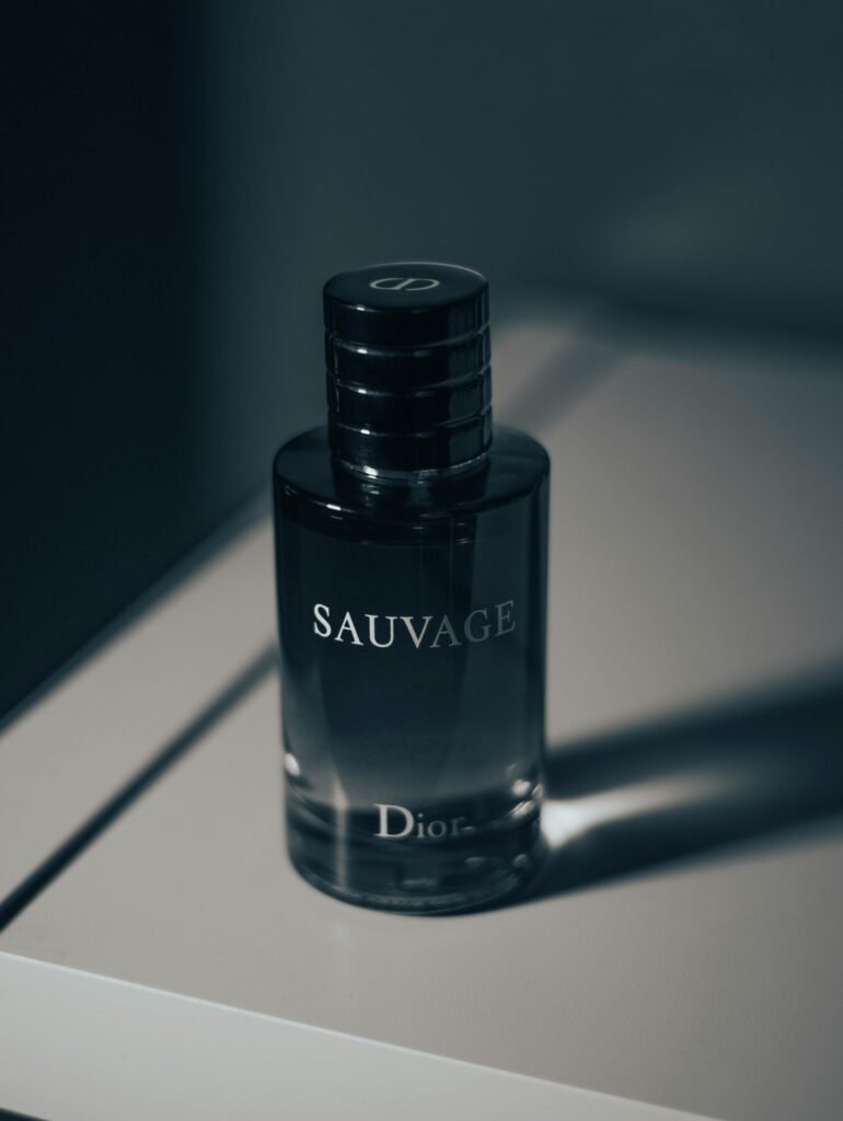 Stylish close-up of Dior Sauvage perfume bottle, highlighting luxury design and branding.