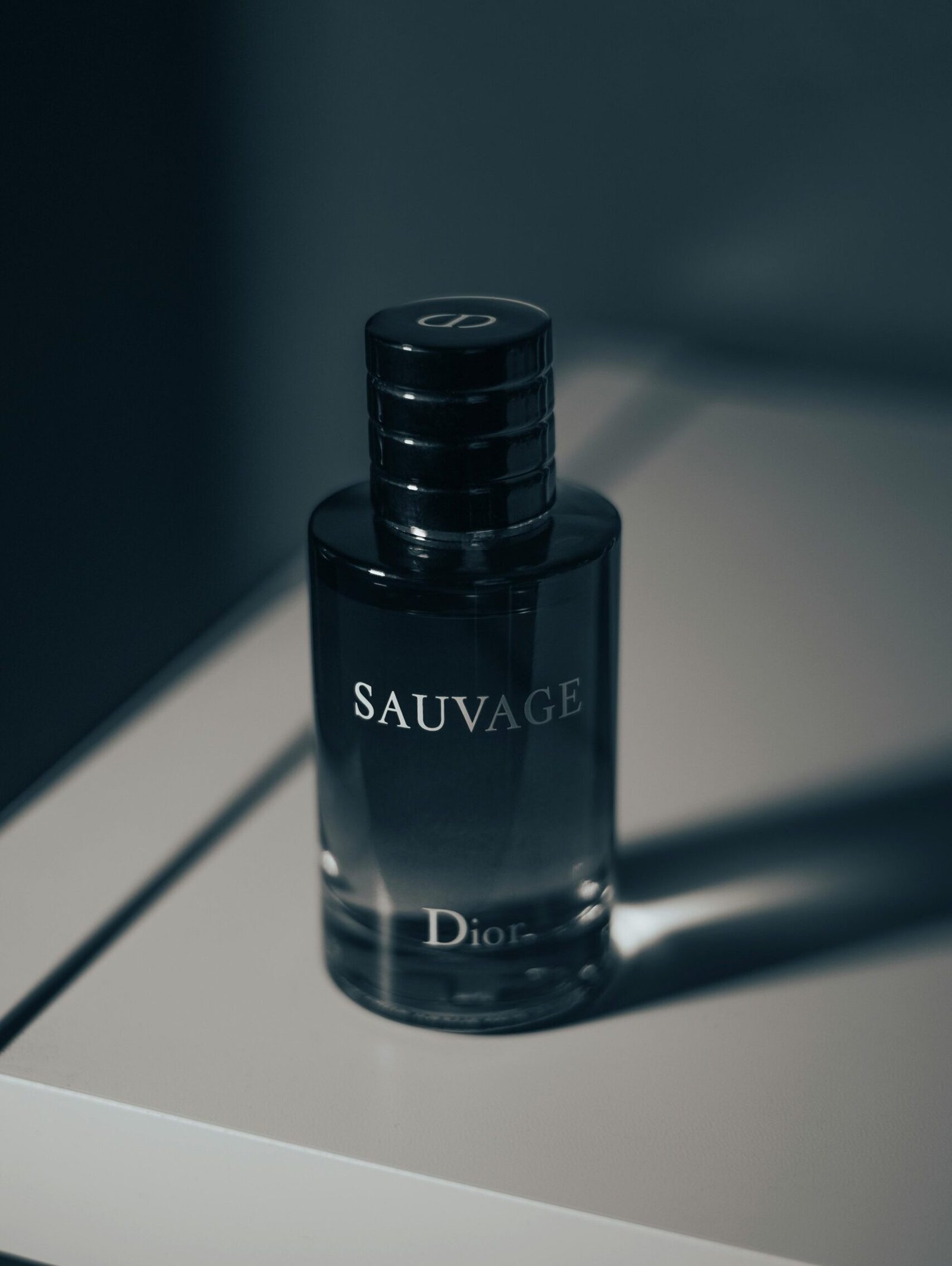 Stylish close-up of Dior Sauvage perfume bottle, highlighting luxury design and branding.